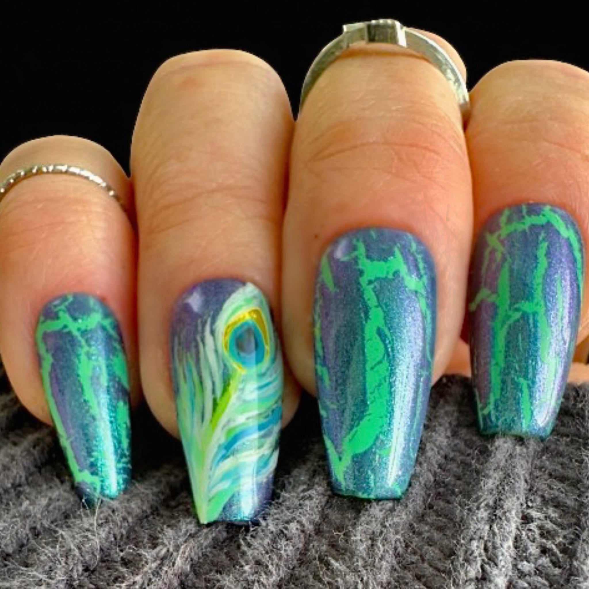 Elegant 2025 Shimmering Peacock Nail Trend